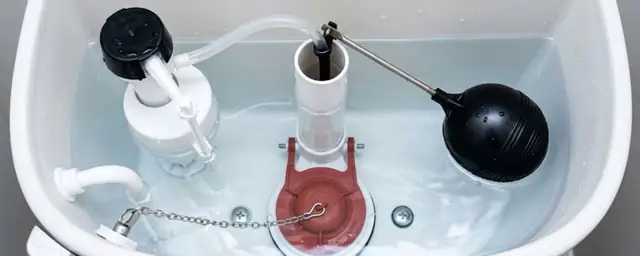 Open toilet tank showing the fill valve, float and flapper